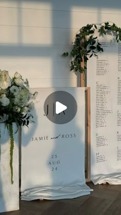 two white vases filled with flowers sitting next to each other on top of a wooden floor