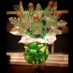 a vase filled with bottles and green bows