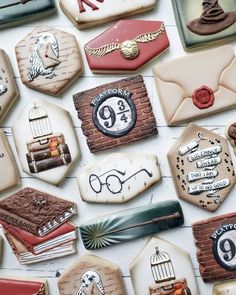 many decorated cookies are arranged in the shape of letters, numbers and other things on display