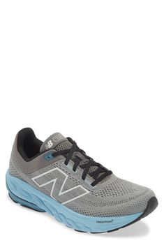 the new balance running shoe in grey and blue