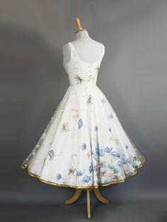 This gorgeous Vintage Style Tea Length Formal Dress is perfect for any special occasion. Crafted of high-quality fabric, it features a retro tea length for a timelessly chic look. Blue poppy embroideries provide an elegant, classic aesthetic for a timelessly stylish look. A stunning choice for an unforgettable night. Bra padding Skirt length approx 28 inches Petticoat required for volume 1950s Tea Length Wedding Dress, 1950s Wedding Dress Tea Length, Tea Length Formal Dresses, Dig For Victory, Blue Poppies, Tea Length Wedding, Tea Party Dress, Dream Dresses, Tea Length Wedding Dress