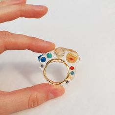 transparent solar system ring big bold statement! i decided to combine two of my favorite motives transparent jelly ring+planets of the solar system it looks like planets floating in space! planets are made of natural stone beads: agate, carnelian, coral, turquoise, lapis lazuli and jade transparent epoxy, gold plated brass i can make it in any size you need, just leave a note with your size while placing an order Solar System Jewelry, Planet Ring, Floating In Space, Handmade Hoop Earrings, Space Jewelry, Botanical Earrings, Space Planets, Transparent Resin, Natural Stone Beads