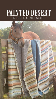 a brown horse standing next to a blanket on top of a wooden fence with text overlay reading painted desert ruffle quilt sets