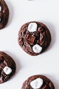 four chocolate cookies with marshmallows on top