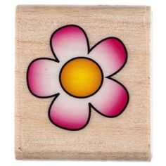 a wooden block with a flower painted on it