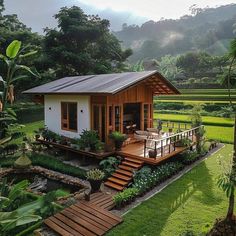 a small house in the middle of a lush green field with stairs leading up to it