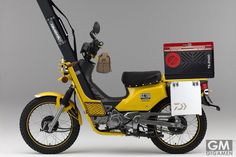 a yellow motorcycle with luggage strapped to it's back end and seat on the front