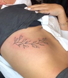 olive branch tattoo,underbreast Rib Olive Branch Tattoo, Olive Branch Shoulder Tattoos For Women, Olive Branch Tattoo Ribs, Olive Branch Hip Tattoo, Olive Tree Branch Tattoo, Olive Vine Tattoo, Small Olive Branch Tattoo, Olive Leaves Tattoo Design, Leaf Branch Tattoo