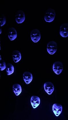 many masks are lit up in the dark