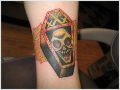 a tattoo with a skull on the arm and an exclamation behind it