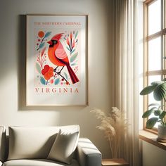 a living room with a white couch and a red cardinal poster on the wall above it