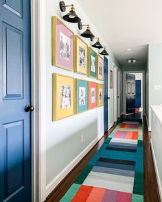 the hallway is decorated with colorful rugs and pictures on the wall, along with blue doors