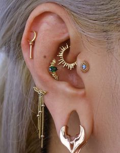 a close up of a person with ear piercings on their ears and behind the ear