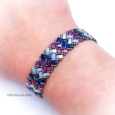 a woman's arm with a bracelet made out of beads and glass cubes