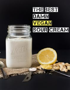 the best vegan sour cream is in a mason jar next to nuts and lemon