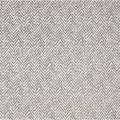 a gray and white rug with an abstract design on it's side, in the shape of zigzag