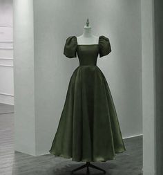 a dress on display in a room with white walls