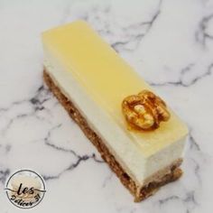 a piece of cake sitting on top of a marble counter next to a golden object