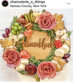 a wreath made out of different types of meats and vegetables with the word thanksgiving written in cursive writing