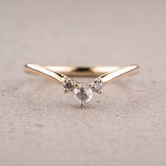 a gold ring with three stones on it