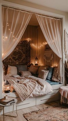 a bed with white curtains and lights on the headboard