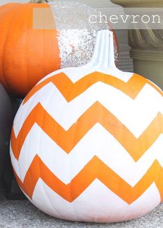 two pumpkins sitting next to each other on the ground