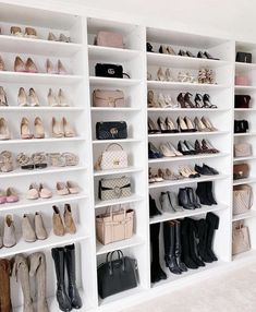 a white closet filled with lots of shoes and handbags on shelving unit shelves