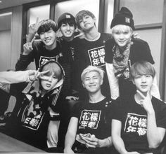 black and white photo of group of boys in t - shirts posing for the camera