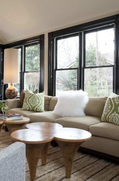 a living room filled with furniture and lots of windows