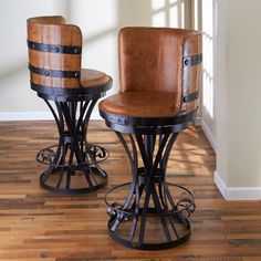 two wooden stools sitting next to each other on top of a hard wood floor