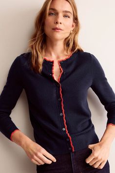 This classic cardigan will be the layer you reach for again and again (probably best to buy a couple). Made with extra fine merino, it's soft enough to wear over a cami or with a short-sleeve tee. The scallop detailing is what really makes it special though. Machine washable. 100% Wool. Chic Prints, Boden Uk, Classic Cardigan, Short Sleeve Cardigan, Lightweight Cardigan, Again And Again, Sleeve Cardigan, Navy Women, Knitwear Women