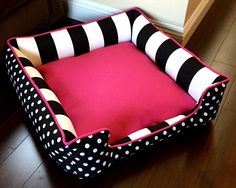 a black and white polka dot dog bed