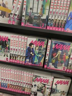 many dvd's are stacked on the shelves in a store with pink and white covers