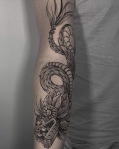 a man's arm with a tattoo on it and a snake in the middle