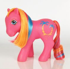 a pink pony with blonde hair and blue eyes standing on a white surface in front of a white background