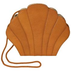 Renaud Pelligrino's elegant caramel "Clam" shaped clutch in textured leather with top stitched accents and rope shoulder strap. 1980's France. Lined in faille. 8" x 9.5" x 1.5". Excellent condition. Ex: Collection of NY Philanthropist Carroll Petrie. Structured Shoulder, Shoulder Bag Brown, Brown Leather Handbags, Brown Brown, Genuine Leather Handbag, Leather Purse, Fashion Handbags, Yorkie, Leather Purses