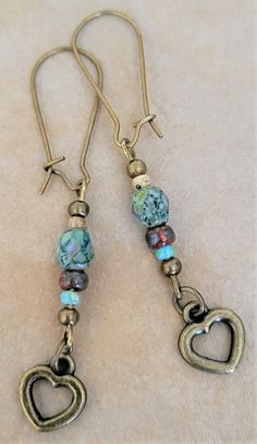 Beautiful, Bronze Tone Heart, Picasso Czech Dangle Earrings.  Earrings have: -an antiqued bronze tone double sided heart charm made of zinc alloy. --Bronze tone, brass hook kidney shaped earwires. -Picasso finished Czech fire-polished bead and seed beads. -Earrings measure 2 3/8 inches long from end to end. Earrings have an antiqued look and feel to them. They are beautiful and would make a wonderful addition to any wardrobe. Item # BHC100 Brass Hook, Beads Earrings, Handcrafted Artisan Jewelry, Czech Beads, Easy Gifts, Jewelry Designs, Boho Earrings, Artisan Jewelry