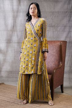 Editor's Note Sarouk yellow embroidered angrakha with palazzo Color: Yellow Fabric: Crepe Components: Kurta and palazzo Occasion: Festive Disclaimer: Colour of the actual product may vary from the image Care: Dry Clean Only About the Designer Soup by Sougat Paul The brand has stood out for its Offbeat state-of-the-art and prints with unique mixing of colors, in silhouettes made to embrace and celebrate Feminity. It aspires to cater to that perfect ensemble to every woman who wishes to endorse be Angrakha Kurta For Women, Angrakha Design, Angrakha Style Kurti, Sougat Paul, Printed Kurti Designs, Yellow Kurti, Angrakha Style, Embroidered Jumpsuit, Printed Embroidery