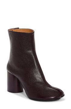 Inspired by the Japanese tabi sock, this iconic split-toe boot is made from supple leather and set on a cylindrical heel that keeps the palette monochromatic. 3" (76mm) heel (size 38.5) 6" shaft Hook closure Leather upper, lining and sole Made in Italy Women's Designer Shoes Modern Calf Leather Platform Boots For Fall, Fall Platform Boots With Sculpted Heel In Calf Leather, Fall Calf Leather Platform Boots With Sculpted Heel, Modern Heeled Boots With Leather Sole, Modern High Ankle Heeled Boots With Leather Sole, Modern Heeled Boots With Contrasting Heel Counter For Fall, Modern Ankle Boots With Rubber Heel Cap, Modern Heeled Boots With Contrasting Heel For Fall, Luxury Ankle-high Platform Boots For Fall