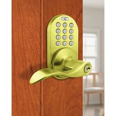 an electronic door lock on the side of a wooden door with a green keypad