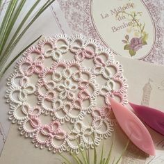 a crochet doily and some scissors on top of a piece of paper