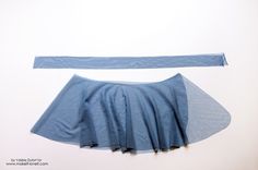 a piece of blue material is shown on a white surface, with the fabric pulled back to reveal it's pleated edges