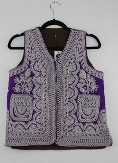 A rare find vintage sleeveless waistcoat from Afghanistan. Size: S/M Bust: 17 Inches Height: 21.5 Inches Note: Worn and minor signs of wear. Sleeveless Winter Vest For Festivals, Vintage Sleeveless Winter Vest, Purple Cotton Sleeveless Vest, Fitted Sleeveless Vest For Festival, Purple Sleeveless Cotton Vest, Folk Style Sleeveless Summer Vest, Sleeveless Folk Style Summer Vest, Traditional Sleeveless Winter Vest, Folk Style Fitted Festival Vest