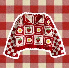 a red and white checkered table cloth with an image of a sweater on it