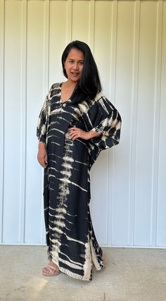 This kaftan, made from rayon fabric and hand dyed, is versatile for many occasions. It complements all body types with its long, hangs loose design and slits up both sides. It can be worn in many different stylish ways to make you look your best! DETAIL • All measurements are flat• Bust/ Waist/ Hips 34 in. (Circumference 68 in.)• Arms 11 in. (Circumference 22 in.)• Length 50 in. The model wear • V-Neck • Side slits• No pocket• Slipover style• All above measurement are flatFABRIC• 100% Rayon FIT• Flowy Maxi Dress With Natural Dye, Black Batik Print Kaftan For Summer, Black Batik Print Kaftan, Flowy Tie Dye Kaftan Tunic, Tie Dye Flowy Tunic Kaftan, Flowy Tie-dye Tunic Kaftan, Flowy V-neck Tie Dye Kaftan, Black Batik Print Kaftan For Beach, Black Batik Print Beach Kaftan