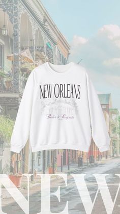 a new orleans sweatshirt hanging on the side of a building in front of a street