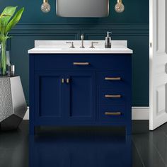 a bathroom with blue walls and white counter tops