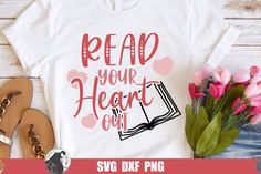 a t - shirt with the words read your heart out on it next to some flowers