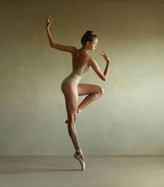 a woman in a leotard is posing for a photo with her legs spread out