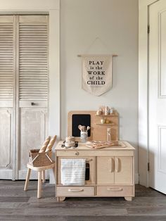 a play kitchen with wooden furniture and accessories